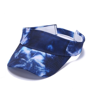 Macro detail of blue tie-dye sun visor hat showing reinforced stitching on the wide brim