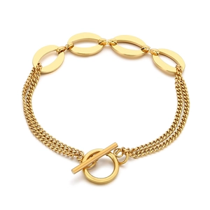 Double-layered gold chain bracelet featuring smooth oval charms and a classic OT toggle clasp
