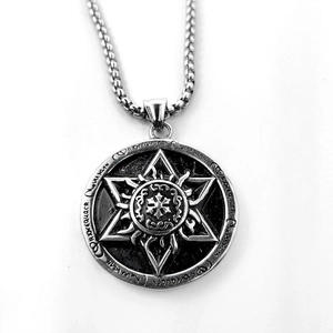 Macro view of silver Horus hexagram pendant with ancient mystical engravings on steel