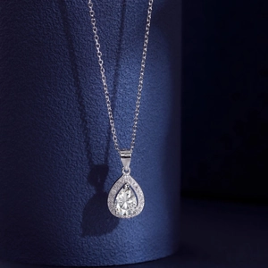Close-up of a pear-shaped cubic zirconia pendant with pavé setting on a silver chain