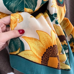 Detailed macro view of the sunflower print fabric and twill texture on the scarf