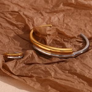 Detailed view of bicolor 18K gold and silver plated crossover open cuff and ring set