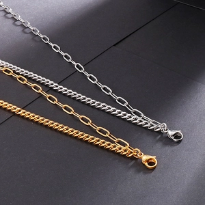 Gold and silver stainless steel layered link chains with lobster clasps on textured background