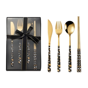Golden 304 stainless steel cutlery set with black patterned handles in a black gift box