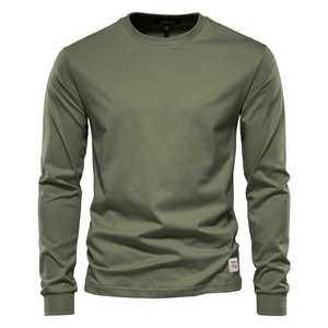 Detail of olive green cotton shirt showing white hem label and neckline brand tag