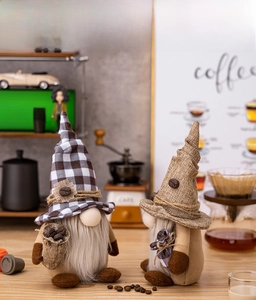Detail of two handmade coffee gnomes with plaid hats and burlap bags on a warm coffee bar
