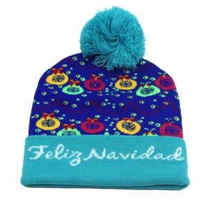 Close-up of blue knit hat with Feliz Navidad embroidery and colorful festive patterns