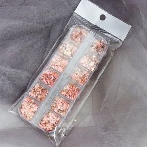 Detail of 12-compartment box with pink and gold star, moon, and heart nail sequins