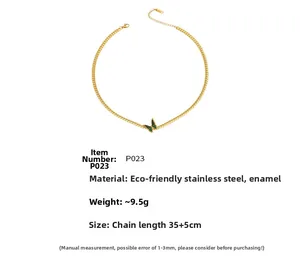 Macro view of gold plated stainless steel snake chain with green oil drip butterfly pendant