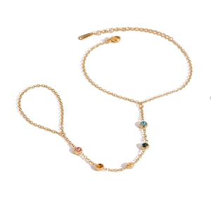 Gold stainless steel slave bracelet featuring multi-color gemstones on white background
