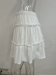 Detail of white multi-layer tiered cake skirt featuring an elastic high waist design