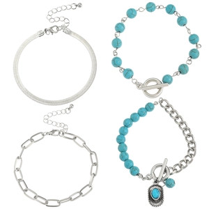 Detail of four-piece silver chain bracelets with turquoise beads and bohemian charms