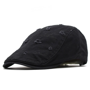 Detailed shot of black cotton ivy cap featuring distressed holes and fashion embroidery