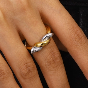 Bague torsadée bicolore en acier inoxydable or et argent portée au doigt
