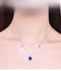 Macro shot of S925 silver necklace with blue gemstone and Capricorn zodiac charm