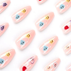 Pink almond press-on nails with colorful smiley face, star, and cloud graffiti patterns