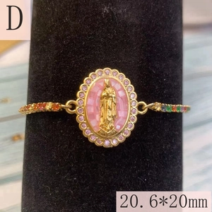 Detail of Virgin Mary Guadalupe oval charm with colorful zircon stones and gold bracelet