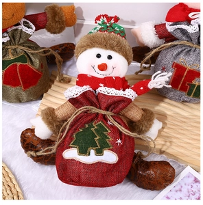 Detailed close-up of a snowman Christmas gift bag with knitted hat and drawstring closure