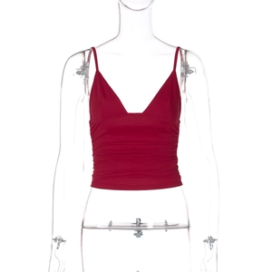Detailed close-up of a red V-neck cropped tank top with ruched texture on a clear mannequin
