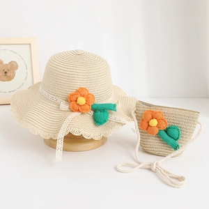 Detail of summer straw sun hat for girls with 3D crochet flowers and lace ribbon ties