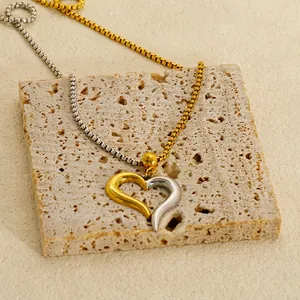 Minimalist two-tone heart pendant necklace in gold and silver stainless steel box chain