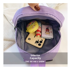 Detailed interior view of a purple nylon backpack showing storage capacity for small items
