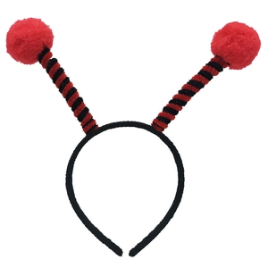 Close-up of insect antenna headband with red plush balls and black spiral wire detailing