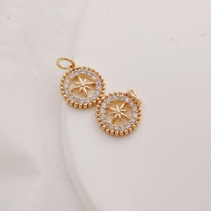Detailed view of 14K gold plated sunburst pendants featuring sparkling zircon stones