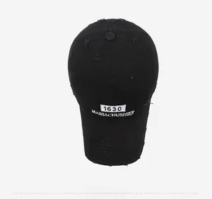 Detailed top view of a distressed black baseball cap featuring white Boston embroidery