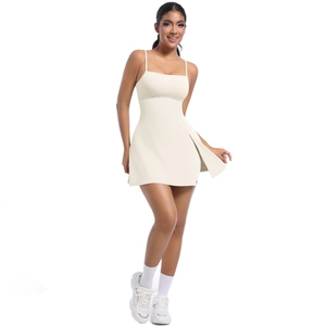 Detail view of cream tennis dress featuring thin straps and stylish side slit design