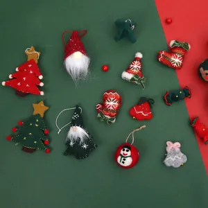 Assorted Christmas felt and knit ornaments including trees and gnomes on a festive backdrop