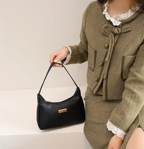 Classic black litchi texture shoulder bag with elegant gold metal accent hardware