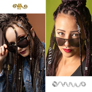 Macro detail of gold and silver spiral rings and metal hair cuffs for dreadlocks styling