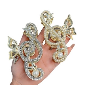Elegant gold musical note hair claw clip with rhinestones and pearl accents for women