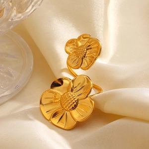 Exaggerated dual flower ring in 18K gold-plated stainless steel on beige silk fabric