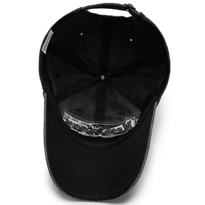 Men's washed cotton baseball cap in black showing interior details and 100% cotton label