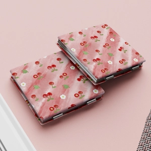 Close-up of square pink cherry pattern folding mirrors with professional metal hinges
