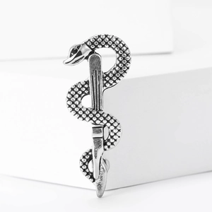 Detailed close-up of a silver snake ear cuff showing intricate scale textures and metallic shine
