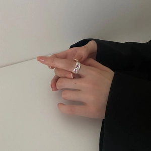 Minimalist 925 sterling silver textured ring with pink gemstones on model hand