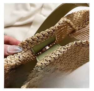 Macro detail of natural straw weave texture with green leather trim and magnetic metal clasp