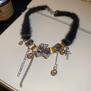 Detail of plush bear choker with tassel chains, pearls and rhinestone star accents
