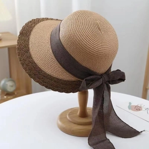 Elegant wide brim straw sun hat for women with a large brown bow and contrast rim