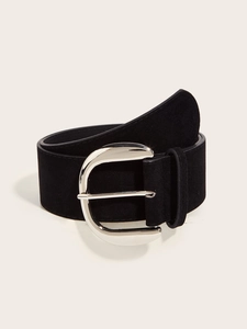Close-up of wide black suede belt with large silver metallic buckle and matte finish