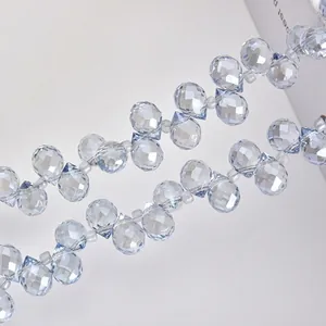 Macro shot of light blue faceted crystal glass drop beads with precision cut for jewelry