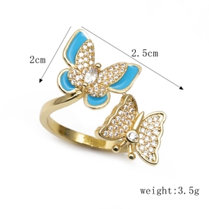 Detailed view of adjustable butterfly ring with blue enamel and zircon inlay