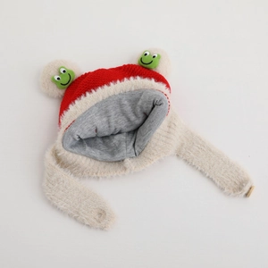 Detail of red and white knit baby hat with warm plush earflaps and green frog eyes