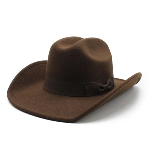 Close-up of a dark brown felt cowboy hat featuring a classic ribbon bow decoration