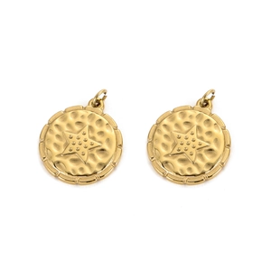 Detailed macro of golden circular pendant with embossed star and hammered metal texture