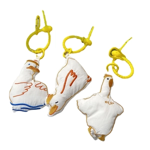 Three-piece set of white stuffed duck pendants with colorful embroidery and yellow hooks
