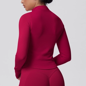 Detail of berry red seamless yoga jacket showing the ribbed texture and fitted back cut